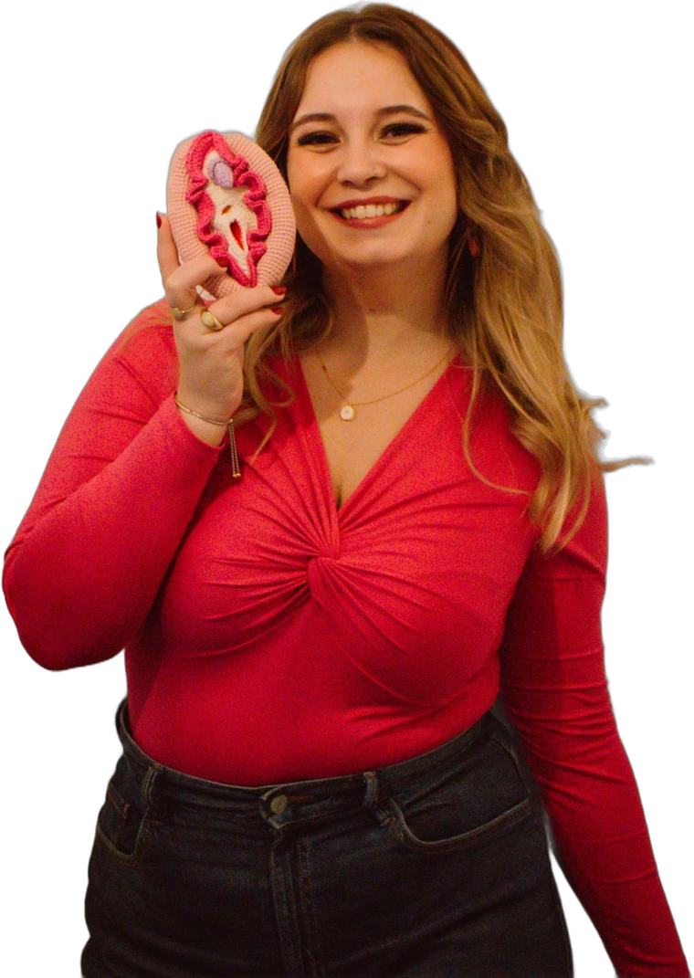 Inês Alexandra a sorrir, com um modelo de vulva em crochet na mão